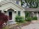 Side entry features a well-lit covered space, complemented by mature landscaping and a brick driveway at 1138 E 58Th St, Indianapolis, IN 46220