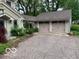 A two car garage with a paved driveway and landscaped yard at 1138 E 58Th St, Indianapolis, IN 46220