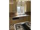 Well-lit kitchen featuring classic cabinetry, functional appliances, and a cozy design perfect for culinary endeavors at 1138 E 58Th St, Indianapolis, IN 46220