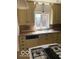 Kitchen with gas stove, white sink, and tile backsplash at 1138 E 58Th St, Indianapolis, IN 46220