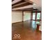 Spacious living room featuring wood beamed ceilings and large windows at 1138 E 58Th St, Indianapolis, IN 46220