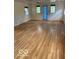 Living room featuring hardwood floors and natural light from multiple windows at 1138 E 58Th St, Indianapolis, IN 46220