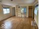 Spacious main bedroom with hardwood floors, natural light, and mirrored closet at 1138 E 58Th St, Indianapolis, IN 46220
