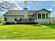 Exterior view of a home with a deck and a well-manicured lawn at 11473 Rainbow Falls Ln, Fishers, IN 46037