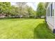 Expansive green lawn and shade trees create a serene backyard oasis at 11473 Rainbow Falls Ln, Fishers, IN 46037