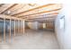Unfinished basement with wooden beams and concrete walls, providing ample storage or potential living space at 11473 Rainbow Falls Ln, Fishers, IN 46037