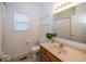 Bright bathroom with a vanity, mirror, toilet, and a plant for decor at 11473 Rainbow Falls Ln, Fishers, IN 46037