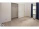 A well-lit bedroom with neutral carpet and a closet with sliding doors at 11473 Rainbow Falls Ln, Fishers, IN 46037