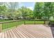 Wooden deck with railing offers outdoor space surrounded by lush greenery at 11473 Rainbow Falls Ln, Fishers, IN 46037