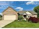Charming single-Gathering home showcasing a lush green lawn, two-car garage, and manicured landscaping at 11473 Rainbow Falls Ln, Fishers, IN 46037
