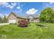 Beautiful brick home featuring a well-manicured lawn and attached two-car garage at 11473 Rainbow Falls Ln, Fishers, IN 46037