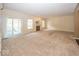Expansive living room features sliding door access to a sunroom and a cozy fireplace at 11473 Rainbow Falls Ln, Fishers, IN 46037