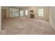 Spacious living room with plush carpeting, a fireplace, a built-in shelving unit and large windows at 11473 Rainbow Falls Ln, Fishers, IN 46037