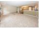 Large living area showcasing neutral walls, plush carpeting and a glimpse into the kitchen at 11473 Rainbow Falls Ln, Fishers, IN 46037