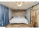 Bedroom featuring wood accent wall, ceiling fan, wood floor, and rustic sliding door at 1157 Fielding Ln, Franklin, IN 46131