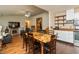 Open dining area with views of the living room, stainless steel refrigerator, and outdoor access at 1157 Fielding Ln, Franklin, IN 46131