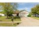 Charming single-story home featuring a well-manicured lawn, brick accents, and attached two-car garage at 1157 Fielding Ln, Franklin, IN 46131