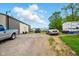 Backyard view of house with a camper, metal building, and several vehicles at 1170 E 400 S, Lebanon, IN 46052