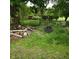 Backyard with overgrown grass, trees, and various outdoor seating options at 1170 E 400 S, Lebanon, IN 46052