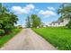 Long gravel driveway leads to the farmhouse, with a school bus and other vehicles parked on the property at 1170 E 400 S, Lebanon, IN 46052