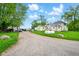 Large lot with a farmhouse style home, propane tank, and a long gravel driveway at 1170 E 400 S, Lebanon, IN 46052