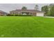 Well-maintained brick home with a lush green lawn and mature landscaping in the front yard at 1209 S Rangeline Rd, Anderson, IN 46012