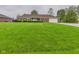 Charming brick home featuring a well-manicured lawn, mature landscaping, and attached garage at 1209 S Rangeline Rd, Anderson, IN 46012