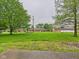 Spacious front yard of the property showcasing lush green lawn and mature trees at 1209 S Rangeline Rd, Anderson, IN 46012