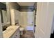 Bathroom featuring a tub shower combination with white cabinetry at 12115 Flagstone Dr, Fishers, IN 46037
