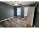 Bedroom with wood floors, gray walls, ceiling fan and bright windows at 12115 Flagstone Dr, Fishers, IN 46037