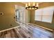 Elegant dining area showcasing stylish flooring, a chandelier and plentiful natural light at 12115 Flagstone Dr, Fishers, IN 46037