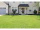 Inviting front entrance with a decorative door, elegant lighting and landscaping at 12115 Flagstone Dr, Fishers, IN 46037