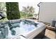 Outdoor hot tub on a brick patio with backyard and trees in the background at 12115 Flagstone Dr, Fishers, IN 46037