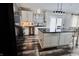 Well-equipped kitchen with island, stainless steel appliances, modern lighting, and sliding doors at 12115 Flagstone Dr, Fishers, IN 46037