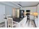 Modern eat-in kitchen featuring an island with seating, stainless steel appliances, and overhead lighting at 12115 Flagstone Dr, Fishers, IN 46037
