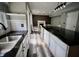 Open kitchen and living area with stainless steel sink, modern cabinets, fireplace, and attractive flooring at 12115 Flagstone Dr, Fishers, IN 46037