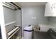 Functional laundry room with modern washer/dryer, water filtration, and storage solutions at 12115 Flagstone Dr, Fishers, IN 46037