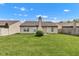 Well-maintained backyard with a lush lawn, home exterior, and mature landscaping at 12256 Sagamore Woods Dr, Fishers, IN 46037