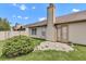 Backyard of a home with a chimney and well maintained landscaping and stone border at 12256 Sagamore Woods Dr, Fishers, IN 46037