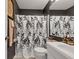 Well-lit bathroom features a shower with leaf-patterned curtain and a vanity with storage at 12256 Sagamore Woods Dr, Fishers, IN 46037