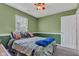 Comfortable bedroom with a ceiling fan, a window with neutral paint and decor at 12256 Sagamore Woods Dr, Fishers, IN 46037