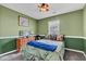 Inviting bedroom with a ceiling fan, large window, and cheerful green color scheme at 12256 Sagamore Woods Dr, Fishers, IN 46037