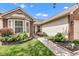 Close up on the charming home's entrance and landscaping at 12256 Sagamore Woods Dr, Fishers, IN 46037