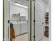 Functional laundry room with washer, dryer, overhead light, and storage shelves at 12256 Sagamore Woods Dr, Fishers, IN 46037