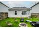 Backyard with a fire pit area, green lawn, and a view of the home's exterior at 1242 Freemont Ln, Greenwood, IN 46143