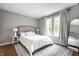 Bright bedroom with a large window, neutral walls, and a decorative rug at 1242 Freemont Ln, Greenwood, IN 46143