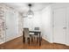 Cozy dining area featuring modern lighting, a table with chairs, and wooden floors at 1242 Freemont Ln, Greenwood, IN 46143