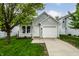 Charming home featuring a well-manicured lawn and an attached one car garage at 1242 Freemont Ln, Greenwood, IN 46143