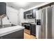Modern kitchen with stainless steel appliances, dark cabinetry, and light countertops at 1242 Freemont Ln, Greenwood, IN 46143