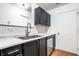 Modern kitchen featuring stainless steel appliances, dark cabinetry, and light countertops at 1242 Freemont Ln, Greenwood, IN 46143